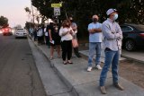 Local Lemoore voters were relegated to the sidewalk as they lined up to enter the Lemoore Masonic Lodge in order to vote in Tuesday's election.